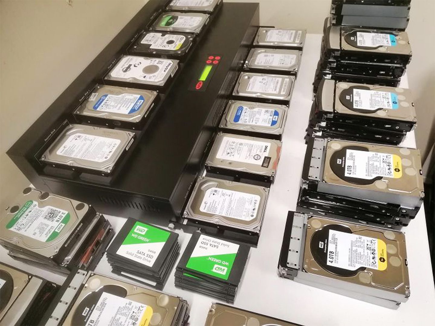 A large group of hard drives and cases on top of each other.