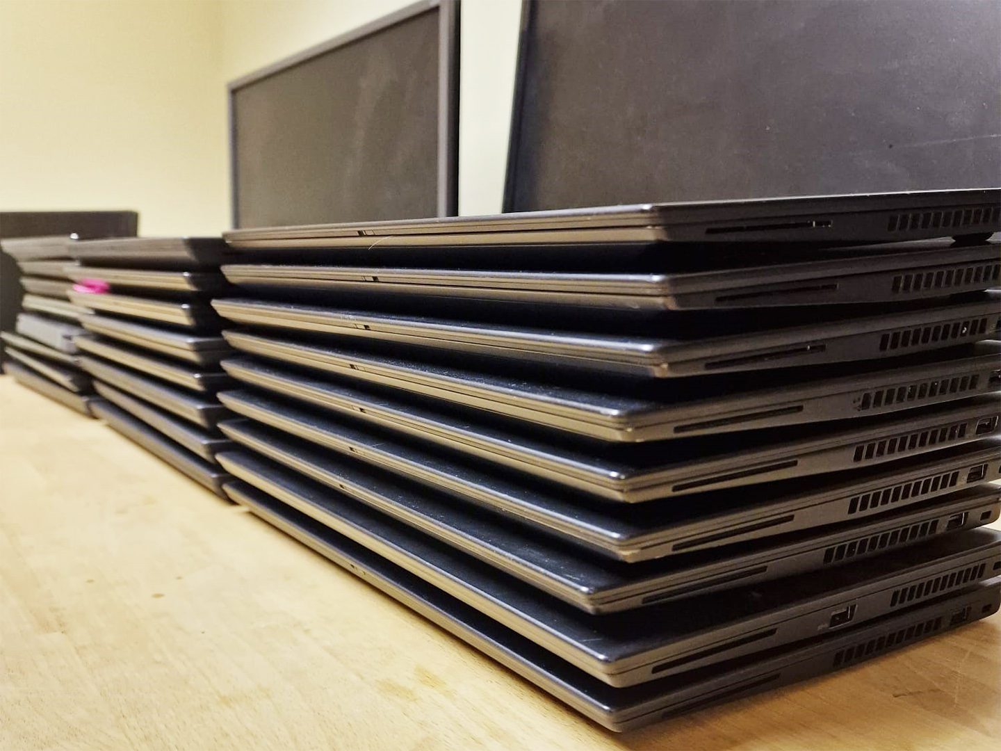 A stack of laptops on top of each other.